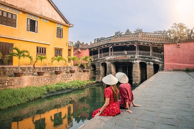 taking photos at the japanese bridge in hoi an